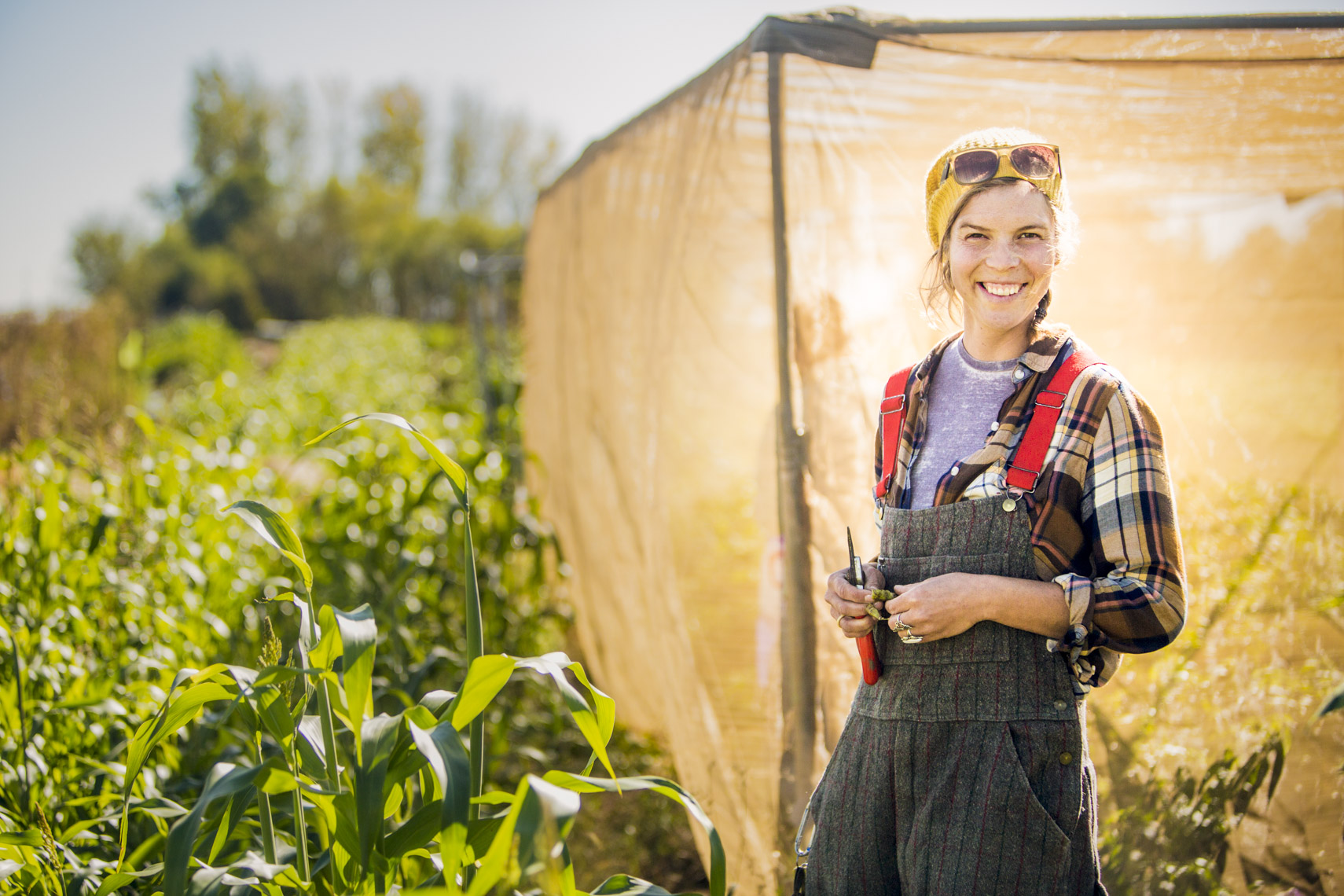A portrait of a woman working near a farm structure  by Washington DC photographer Ryan Donnell