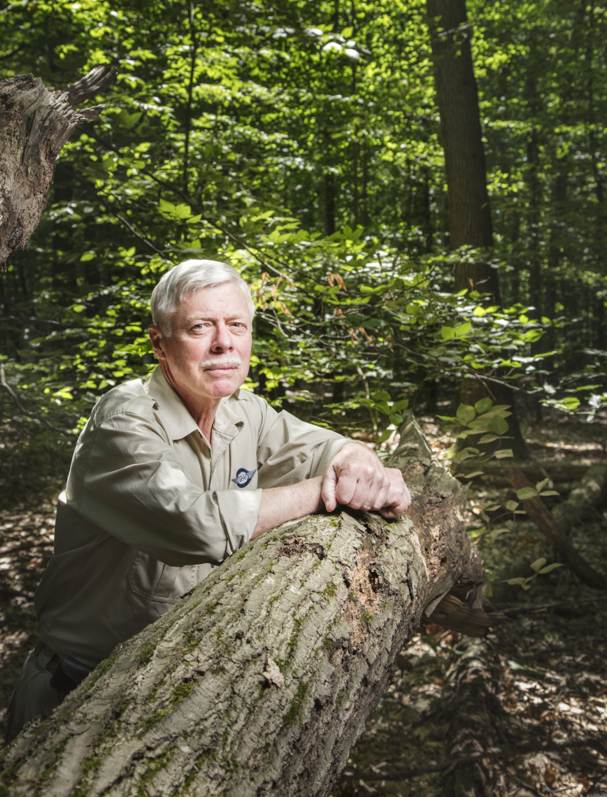 A portrait of a man in the woods leaning on a tree  by Washington DC photographer Ryan Donnell