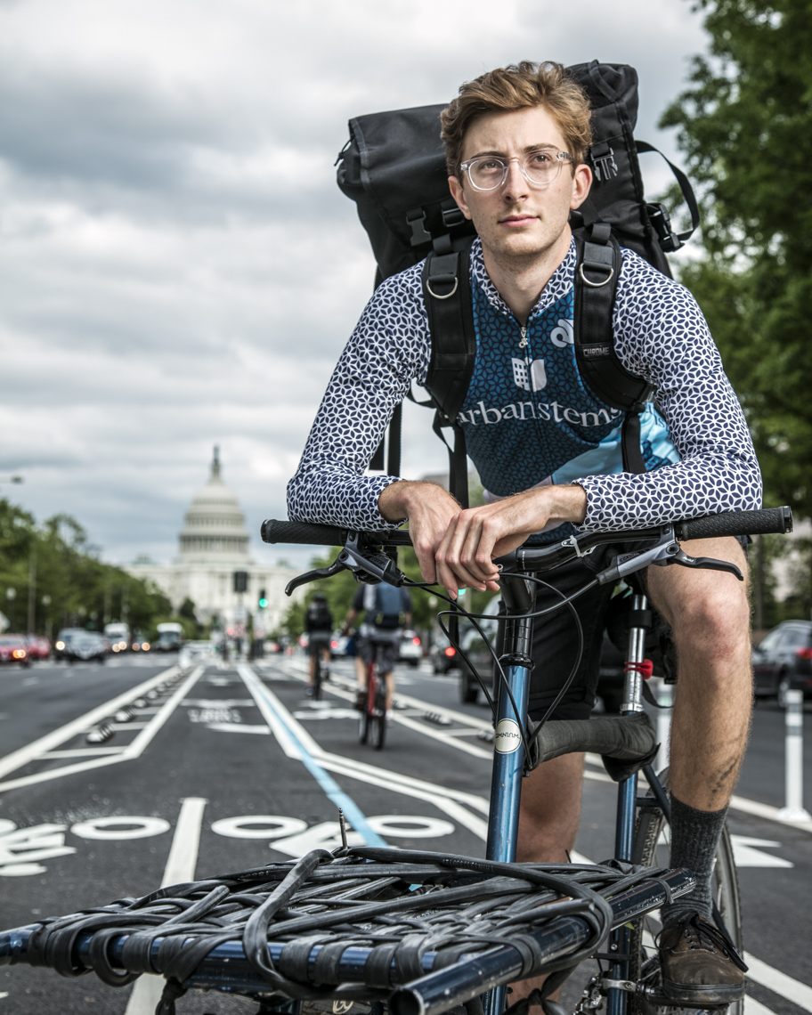 Portrait of caucasian bike messenger in front of US Capitol by Washington DC photographer Ryan Donnell
