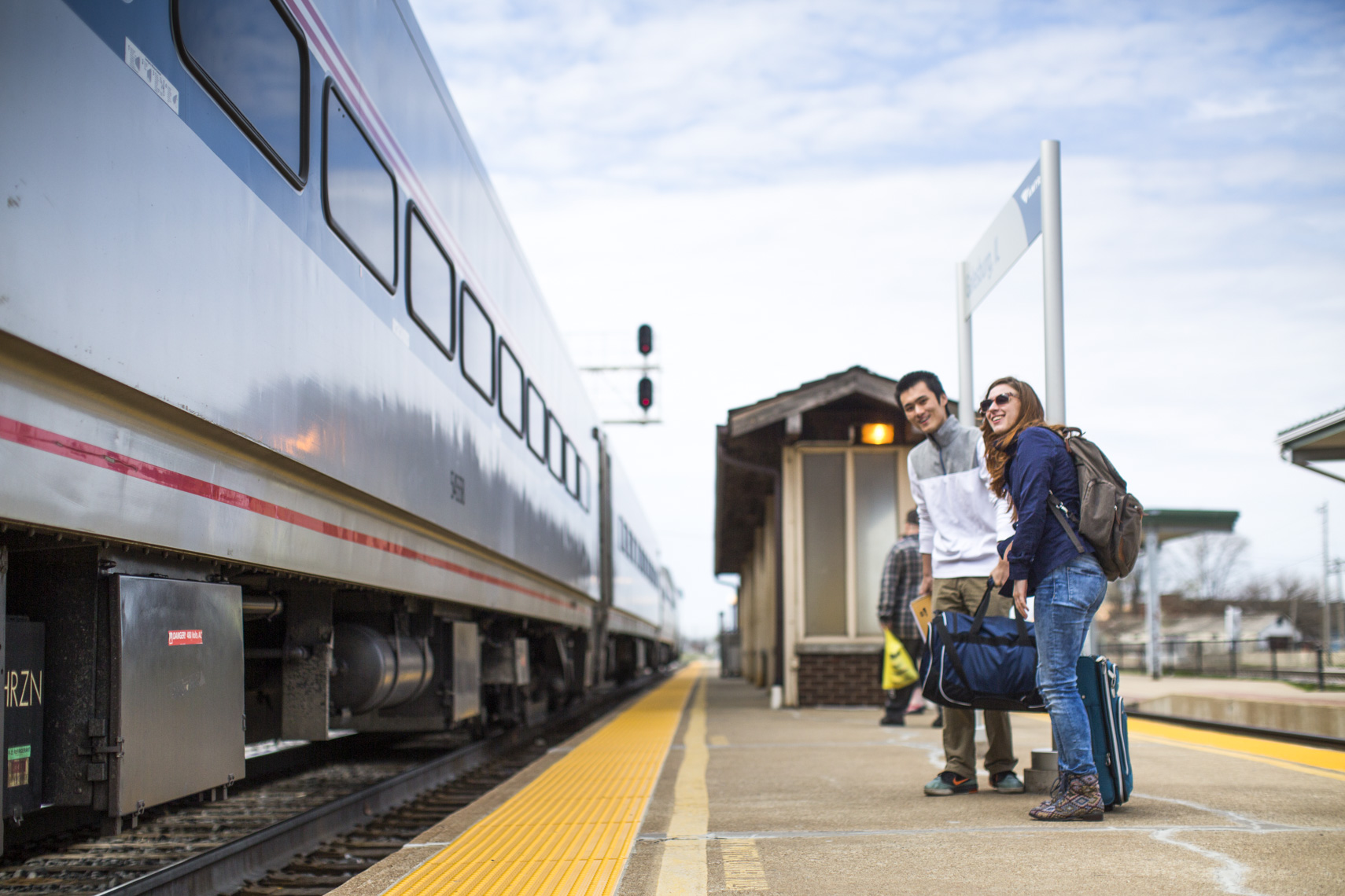 Two students wait to board a train to head home during a spring break in a photo by Ryan Donnell
