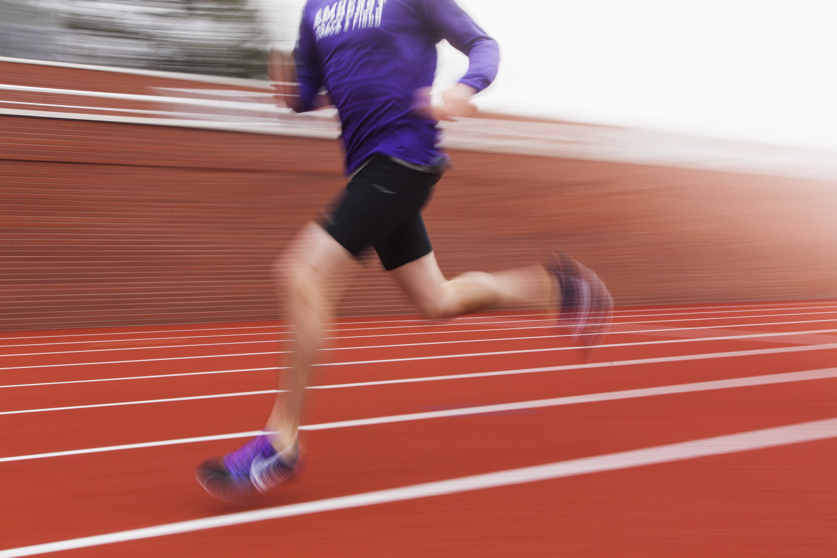 A graphic photo of a student athlete training on a track by Ryan Donnell