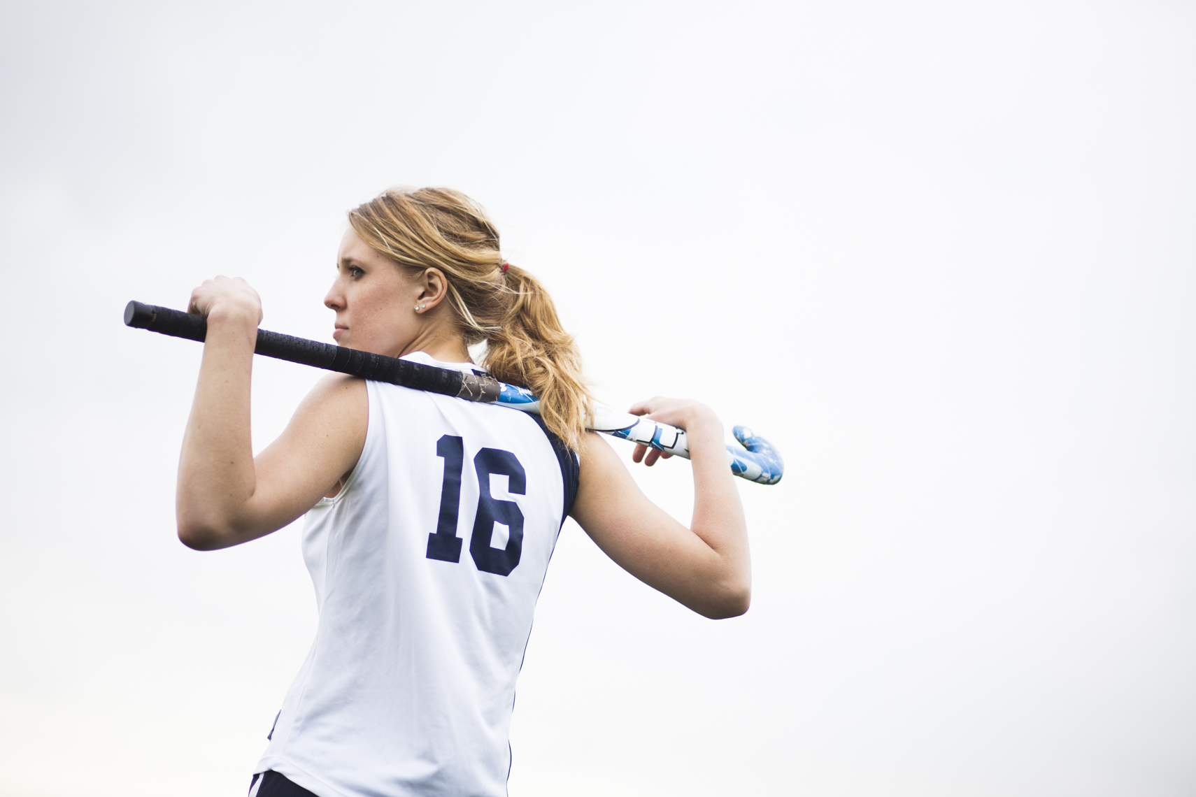 A college field hockey player rests in between plays in a photo by Ryan Donnell