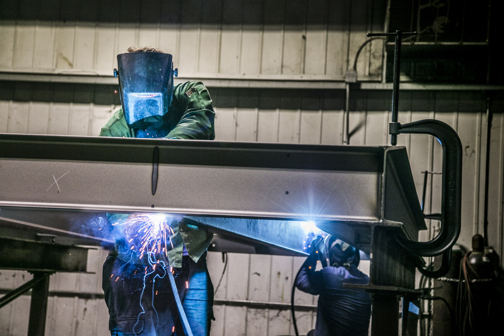 Workers welding metal at a small business in West Virginia.